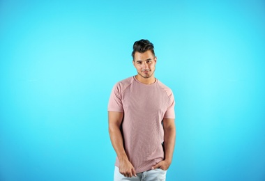 Young man in t-shirt on color background. Mockup for design