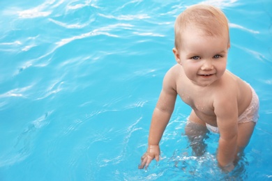 Little baby playing in outdoor swimming pool. Dangerous situation