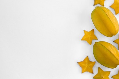 Photo of Delicious cut and whole carambolas on white background, top view