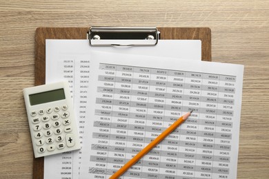 Photo of Accounting documents, calculator, clipboard and pencil on wooden table, top view