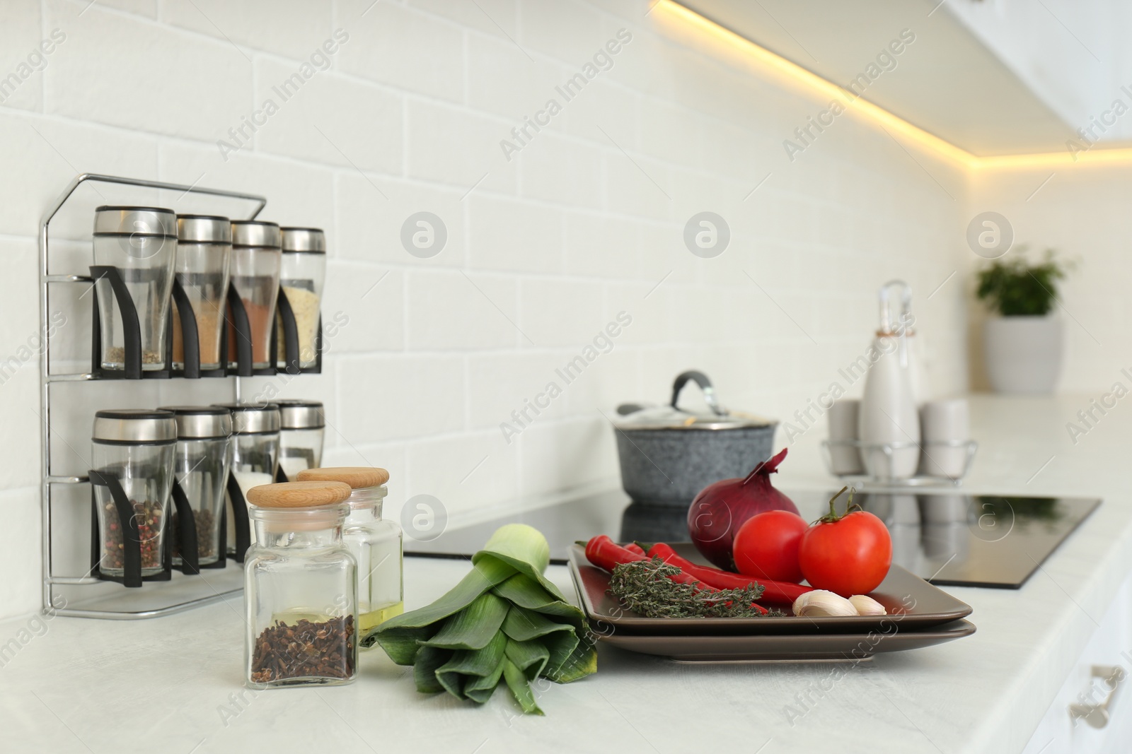 Photo of Fresh vegetables on white countertop in kitchen