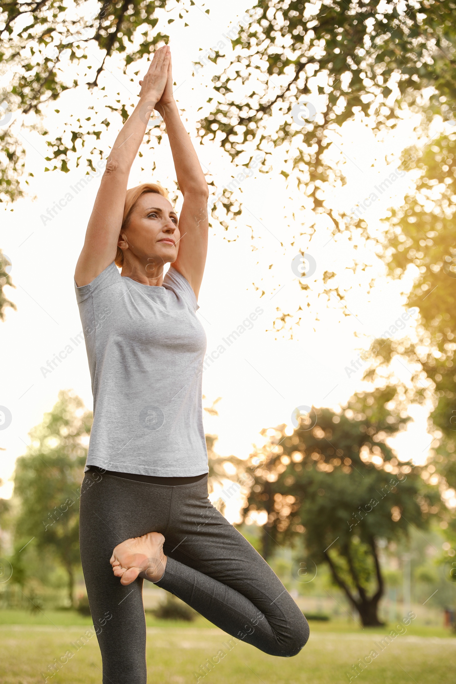 Photo of Woman practicing yoga in park at morning