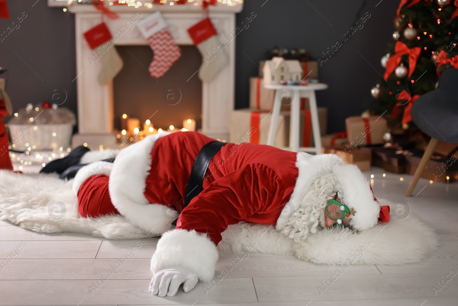 Photo of Authentic Santa Claus lying on floor indoors