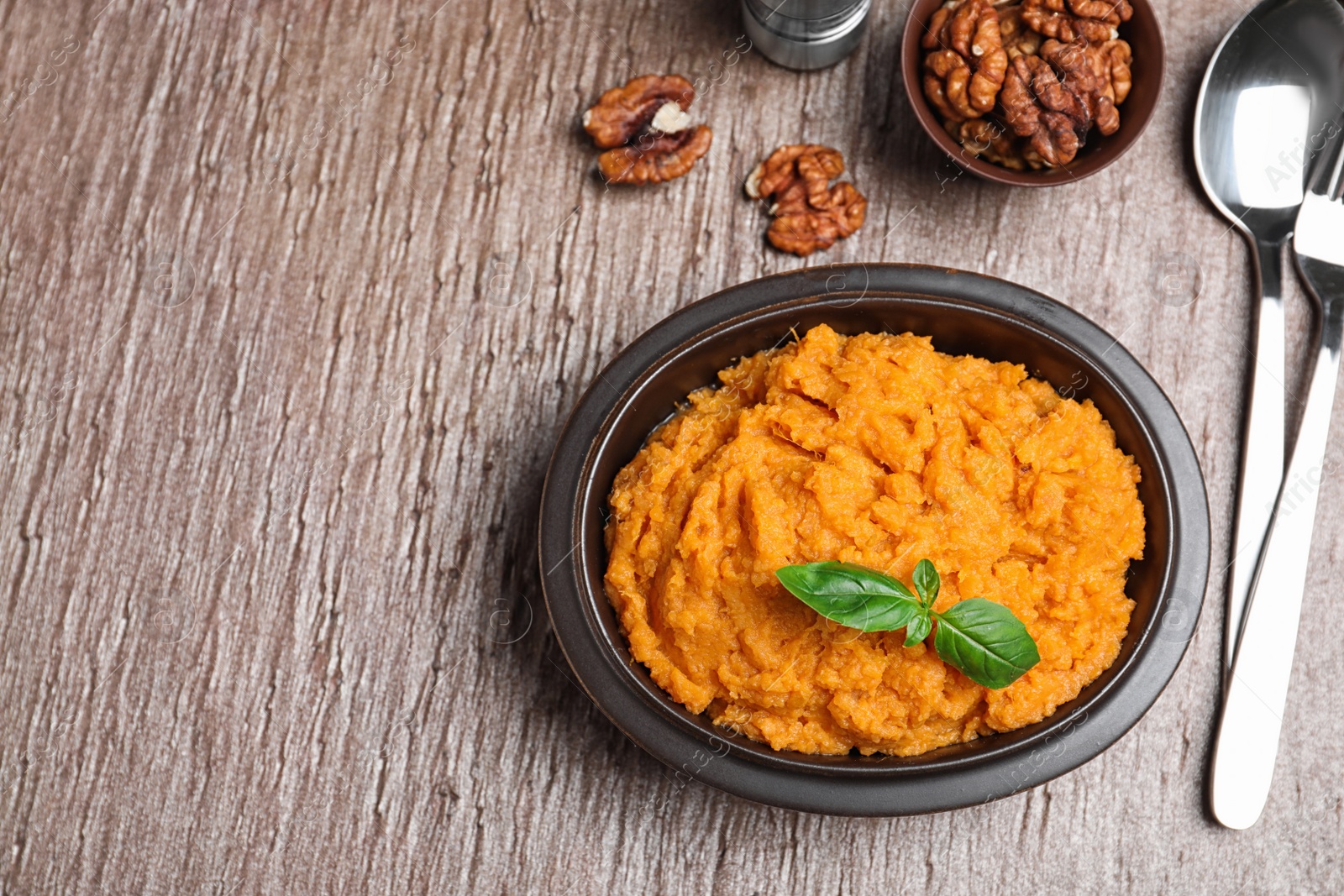 Photo of Flat lay composition with mashed sweet potatoes on brown background, space for text