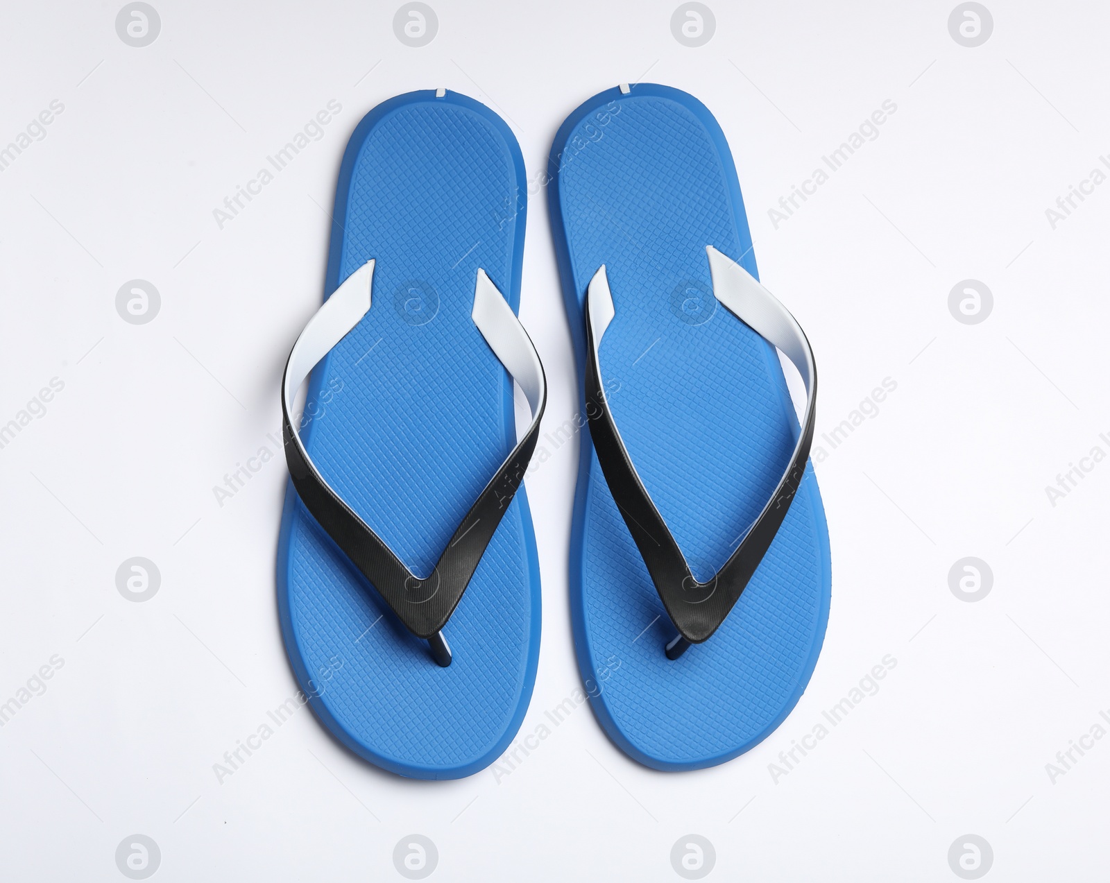 Photo of Pair of flip flops on white background, top view. Beach accessories