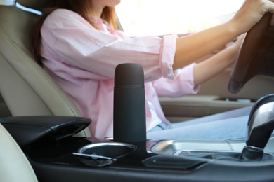 Photo of Black thermos in holder inside of car