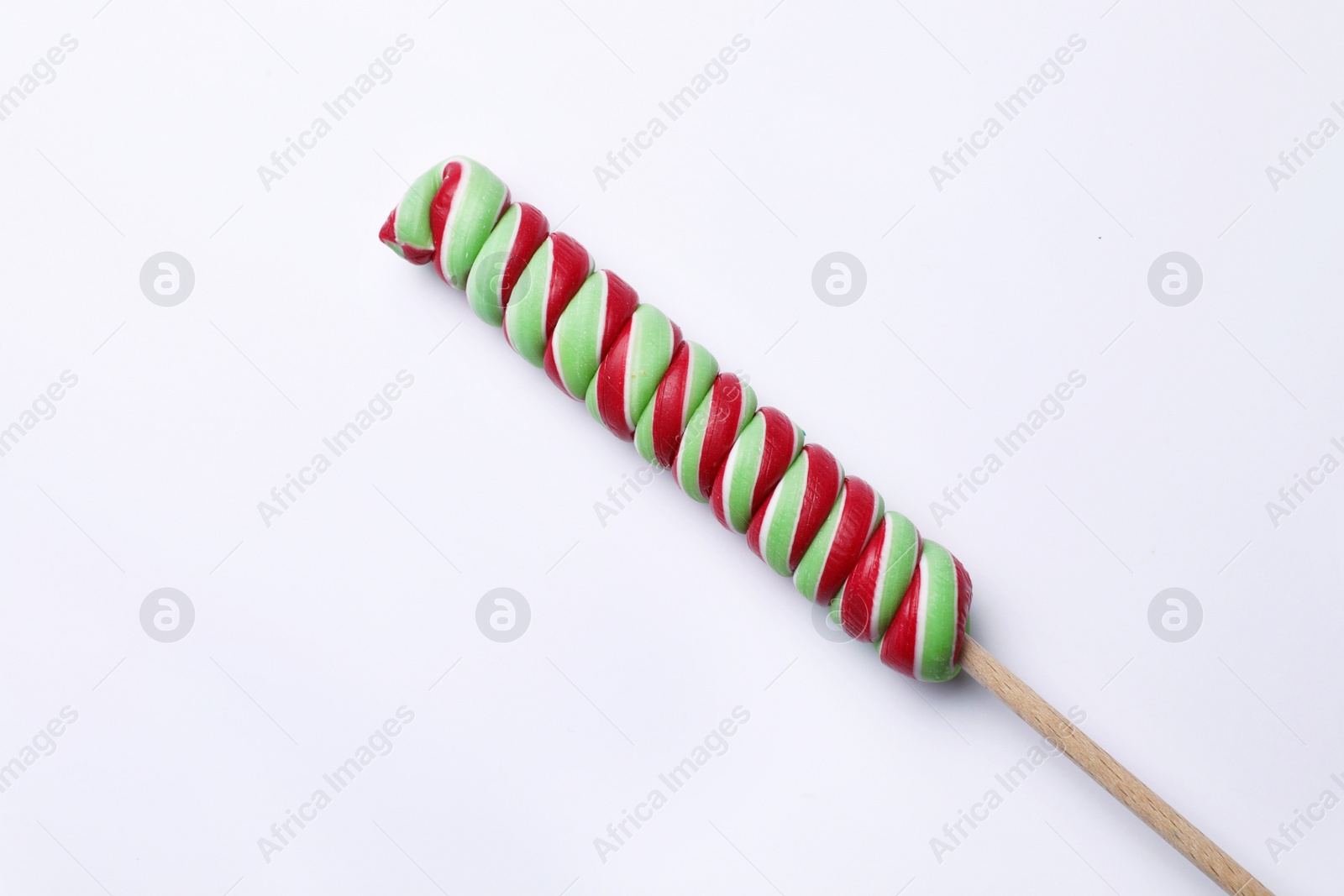 Photo of Sweet colorful lollipop on light background, top view