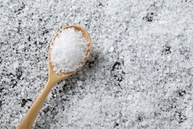 Photo of Natural salt and wooden spoon, top view