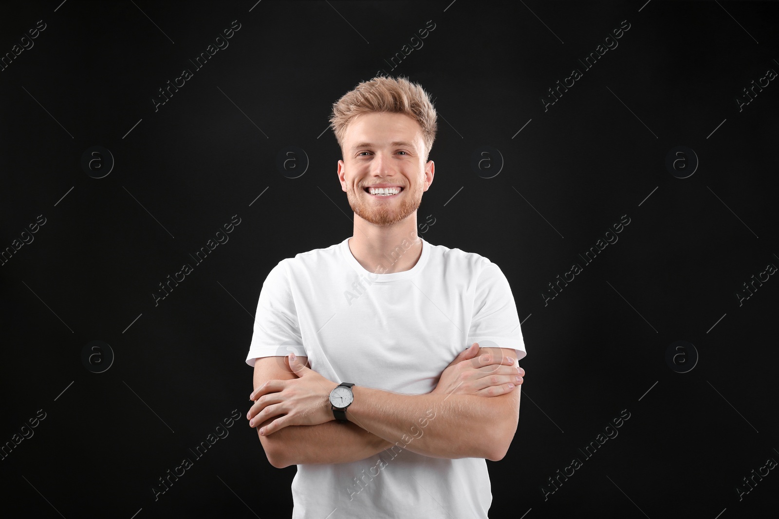 Photo of Portrait of handsome young man on black background