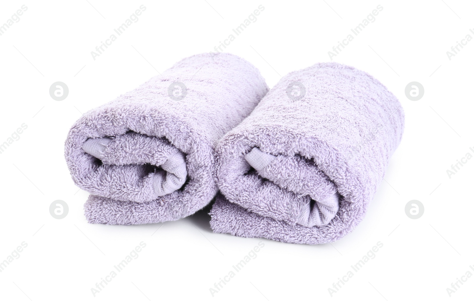 Photo of Rolled violet terry towels isolated on white