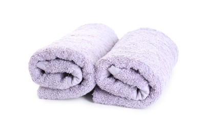 Photo of Rolled violet terry towels isolated on white