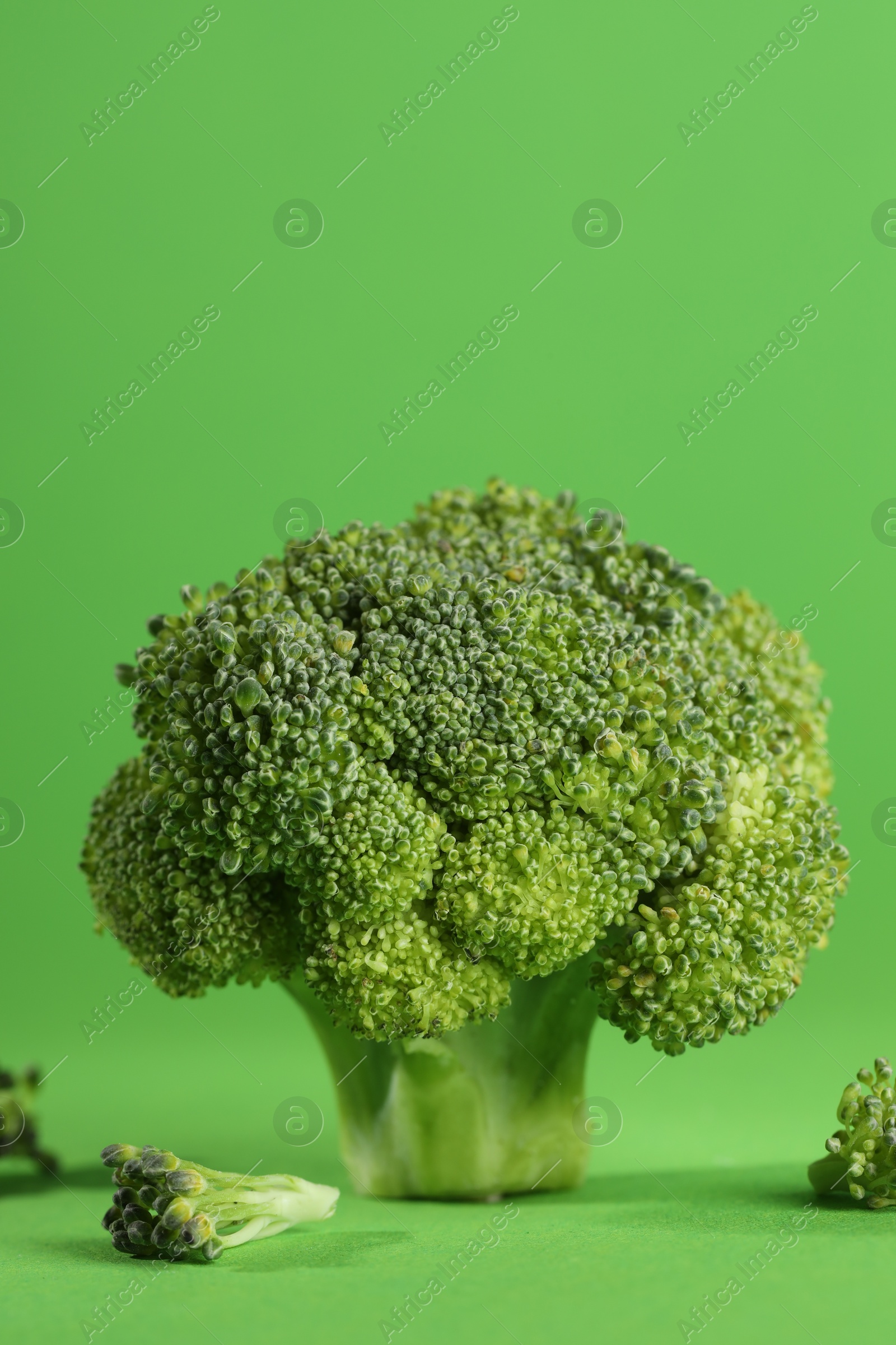 Photo of Fresh raw broccoli on light green background