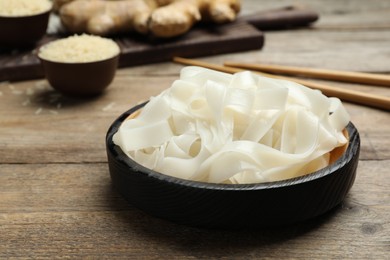 Tasty rice noodles on wooden table, closeup