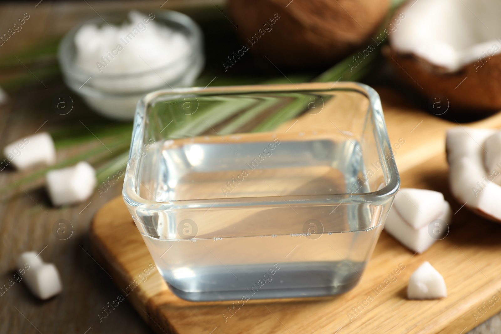 Photo of Coconut oil on wooden board, closeup view