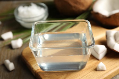 Photo of Coconut oil on wooden board, closeup view