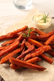 Photo of Delicious sweet potato fries and sauce on table, closeup