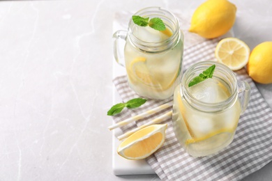 Mason jars of natural lemonade on table