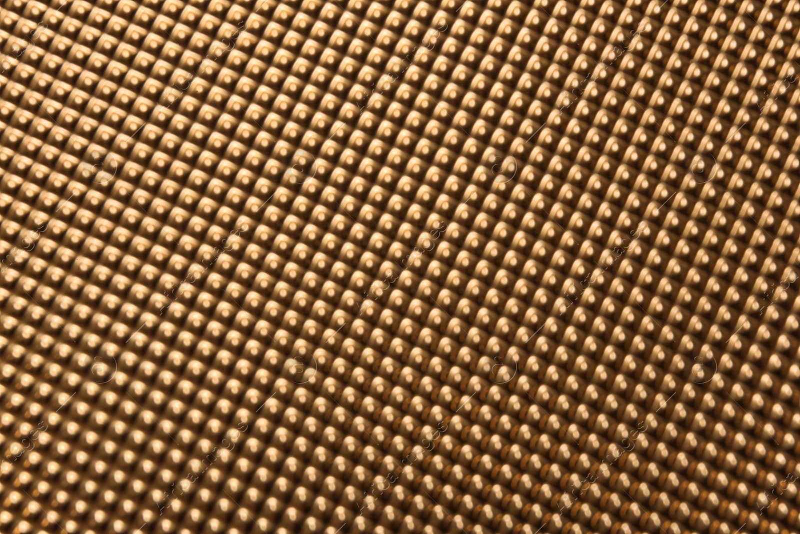 Photo of Blurred view of golden surface as background