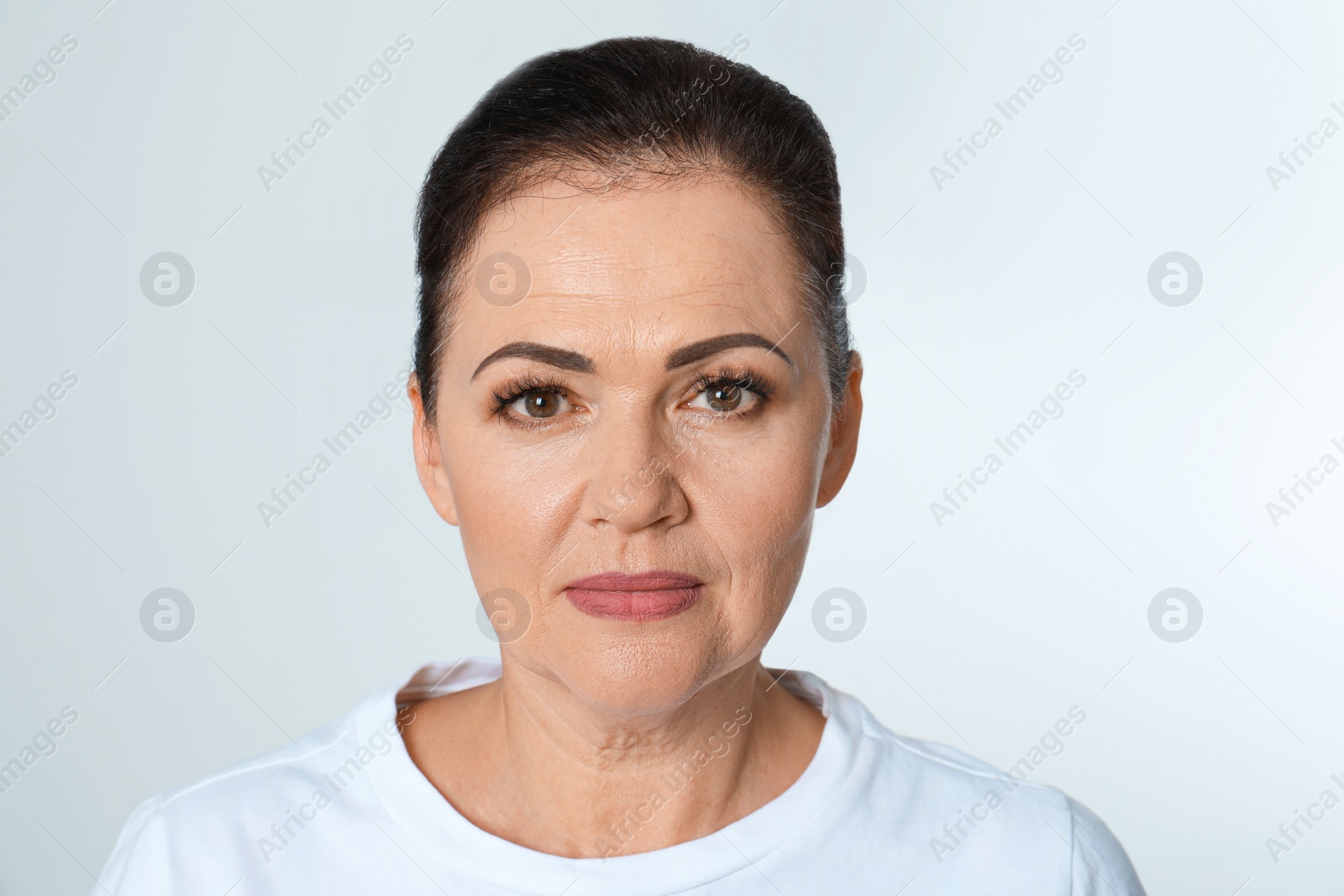 Photo of Portrait of beautiful older woman on white background