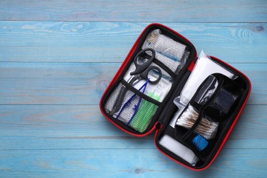 Photo of First aid kit on blue wooden table, top view. Space for text