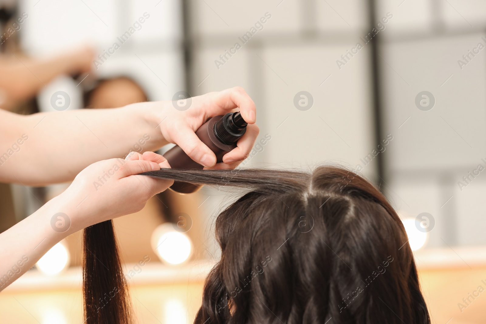 Photo of Hair styling. Professional hairdresser working with client indoors, closeup