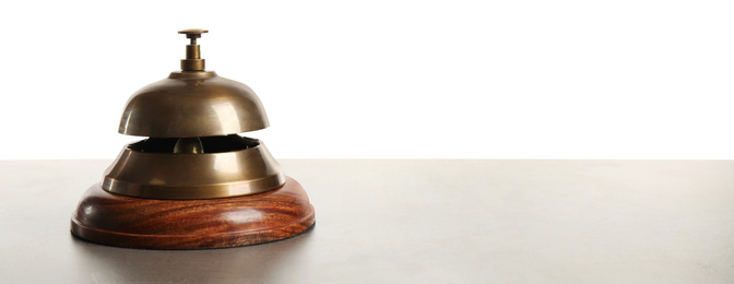 Hotel service bell on grey stone table against white background