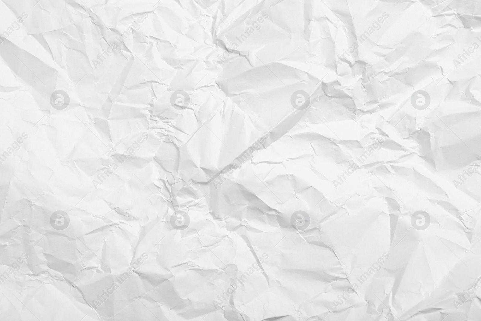 Photo of Sheet of white crumpled paper as background, closeup