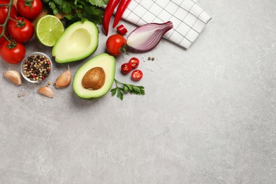 Photo of Fresh guacamole ingredients on light grey table, flat lay. Space for text