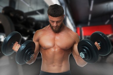 Image of Handsome bodybuilder exercising with dumbbells in gym