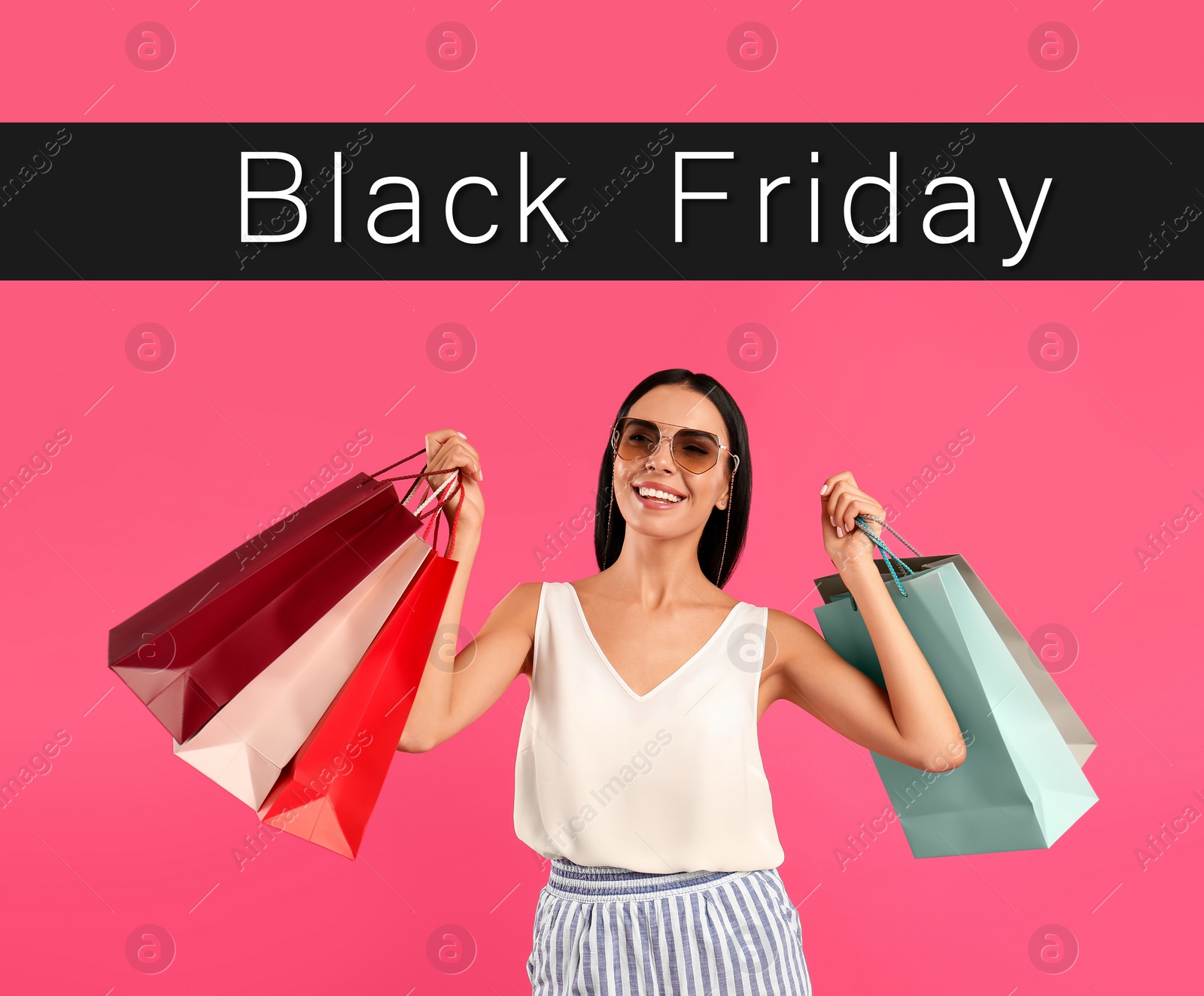 Image of Black Friday Sale. Beautiful young woman with shopping bags on pink background 