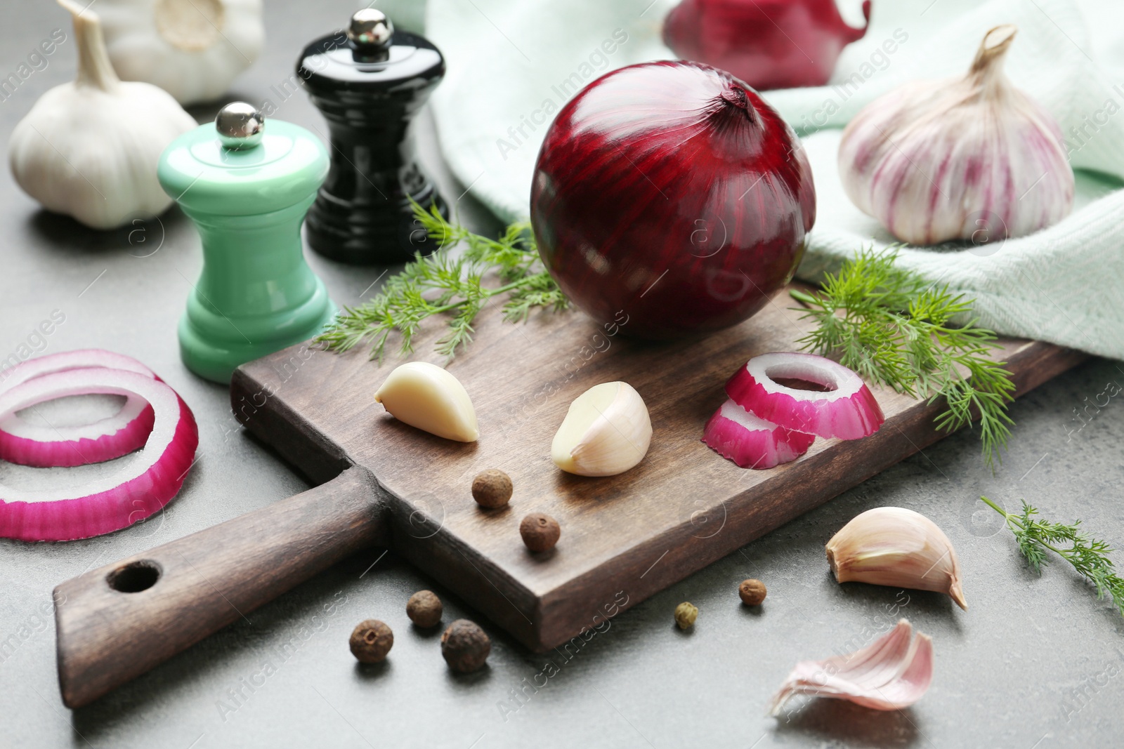 Photo of Composition with onion, garlic and dill on kitchen table