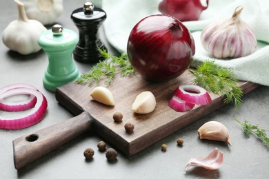 Composition with onion, garlic and dill on kitchen table