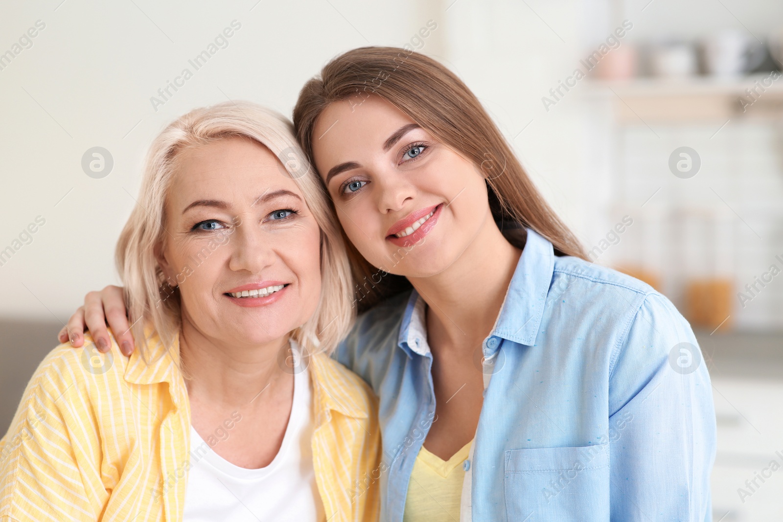 Photo of Portrait of young woman with her mature mother indoors