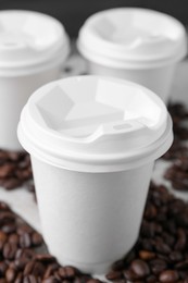 Photo of Coffee to go. Paper cups and roasted beans on table, closeup