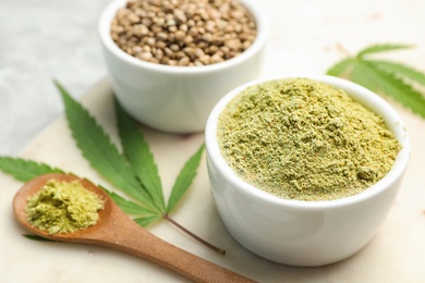 Photo of Composition with hemp protein powder and seeds on marble board, closeup