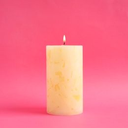 Photo of Alight scented wax candle on color background