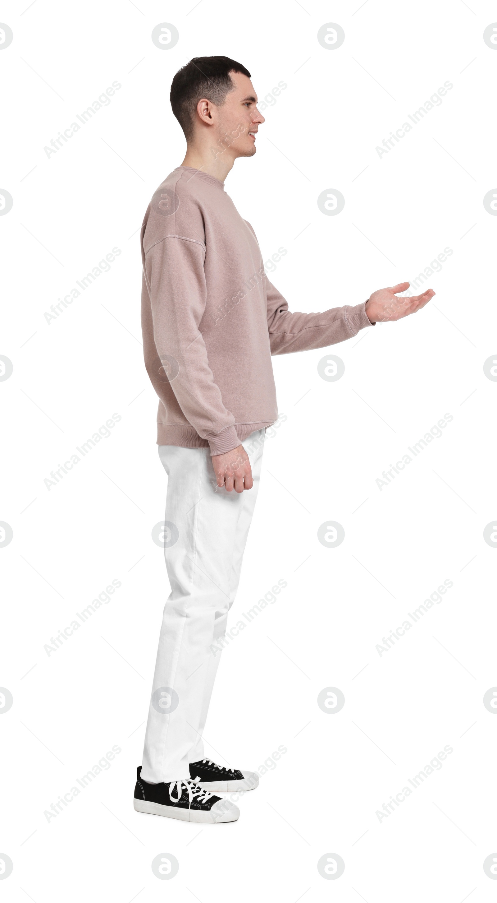 Photo of Handsome young man greeting someone on white background