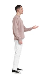 Photo of Handsome young man greeting someone on white background