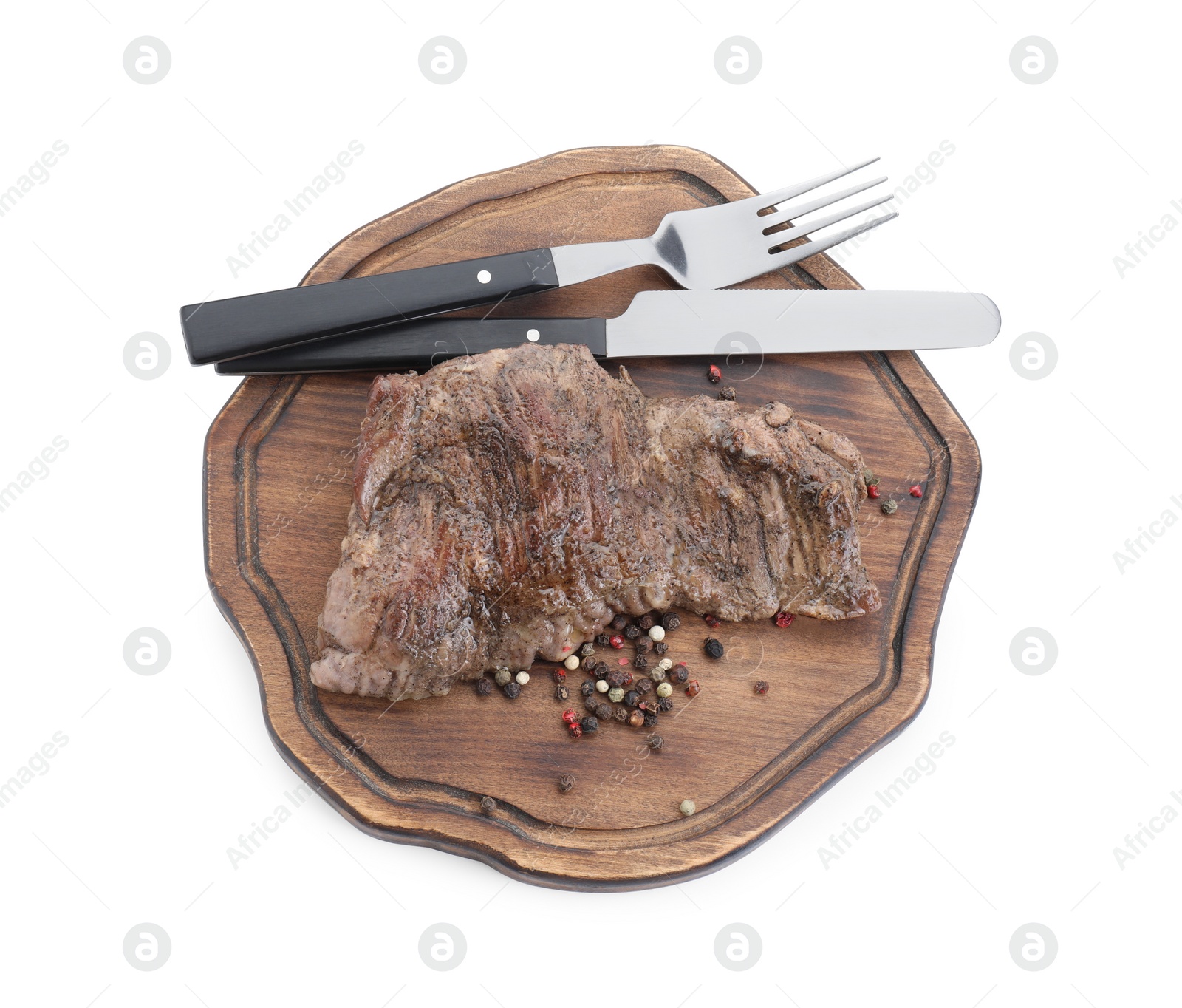 Photo of Piece of delicious grilled beef meat, peppercorns and cutlery isolated on white, top view