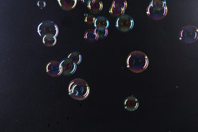 Beautiful transparent soap bubbles on dark background