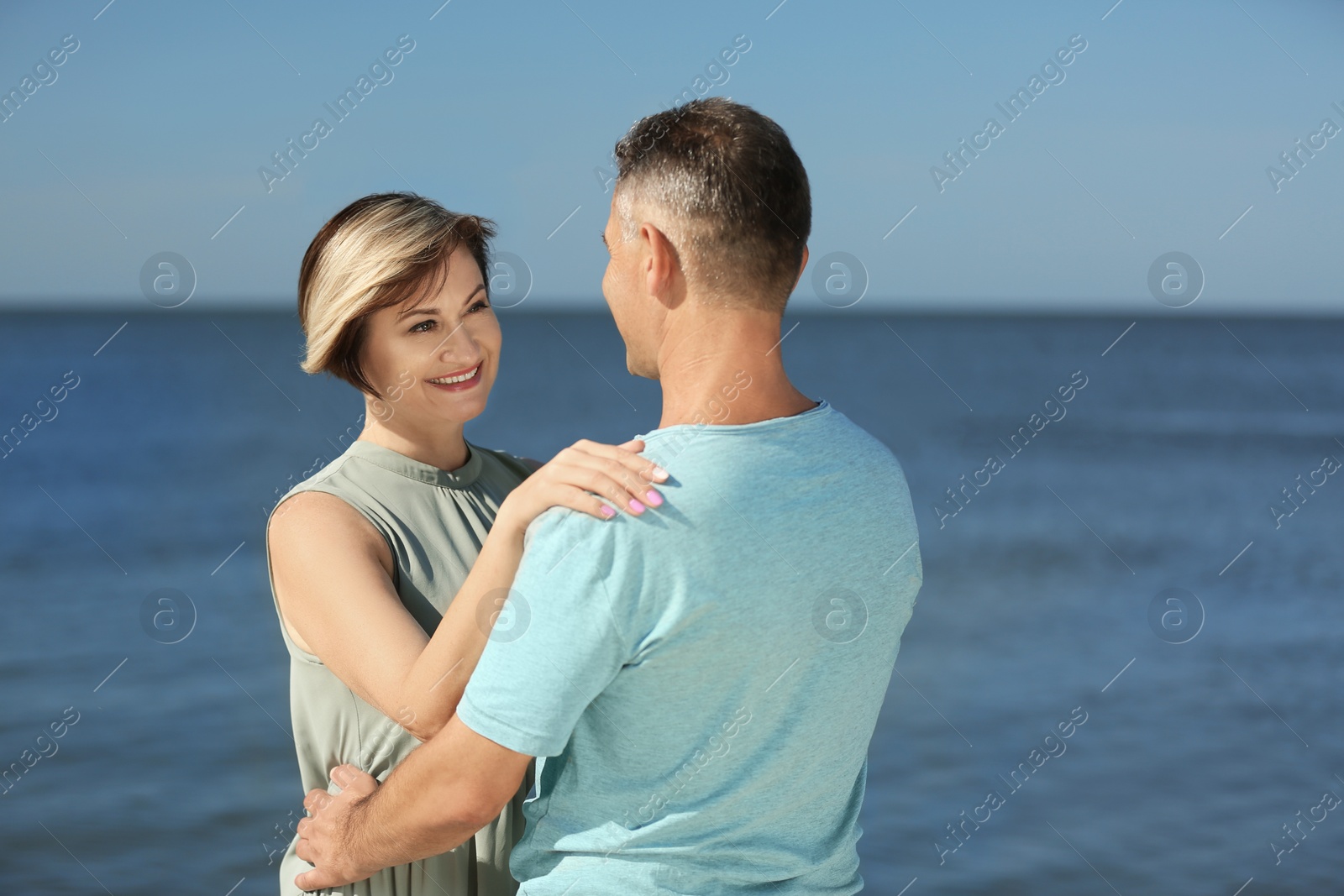 Photo of Happy mature couple at beach on sunny day