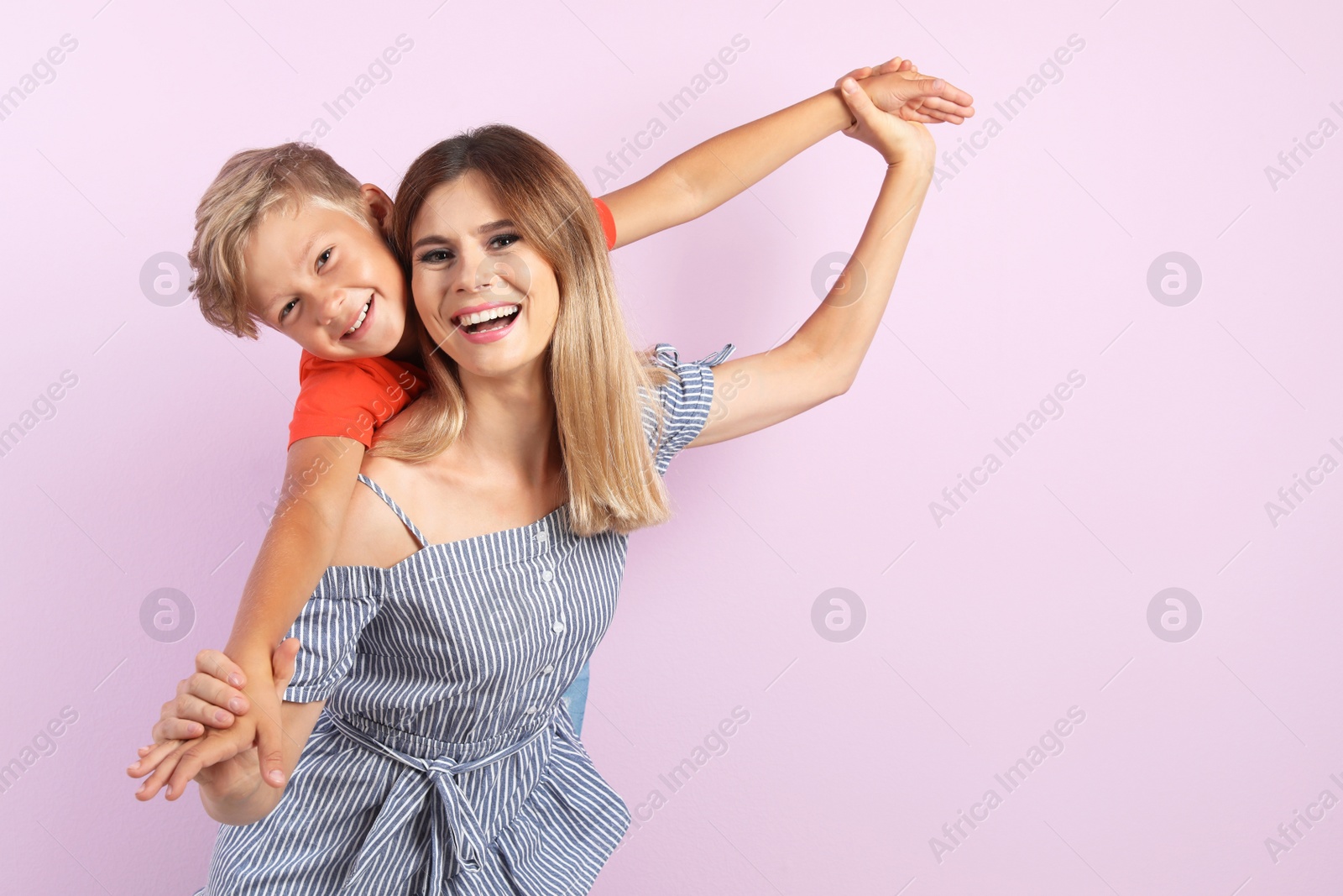 Photo of Portrait of mother and son on color background