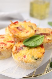 Photo of Freshly baked bacon and egg muffins with cheese on table, closeup