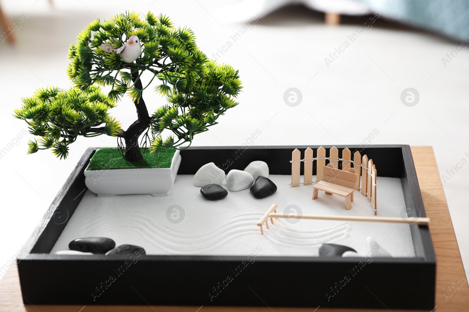 Photo of Beautiful miniature zen garden on wooden table indoors