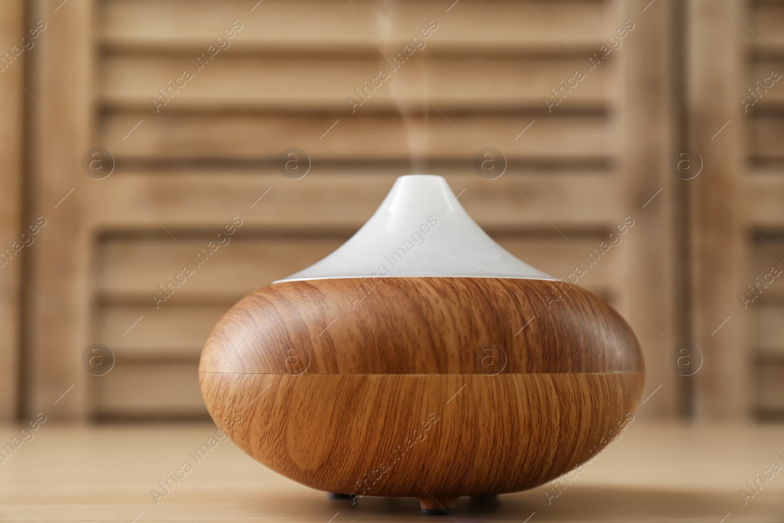 Photo of Modern aroma lamp on wooden table