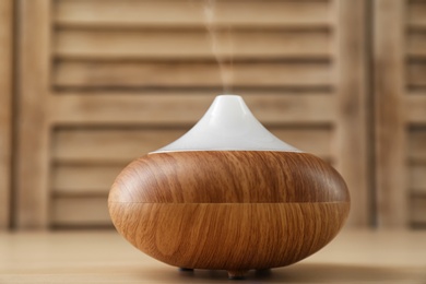 Modern aroma lamp on wooden table