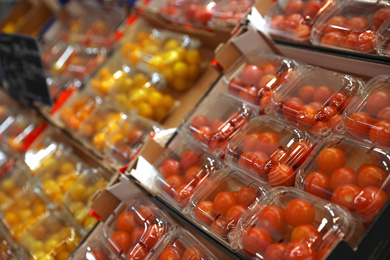 Photo of Fresh ripe tomatoes on counter at wholesale market