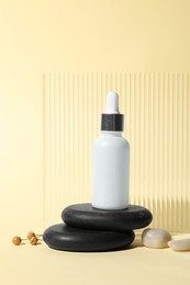 Photo of Composition with bottle of cosmetic serum on beige background