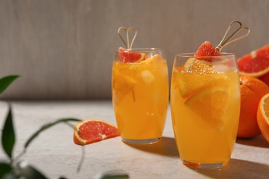 Photo of Delicious orange soda water on light table. Space for text