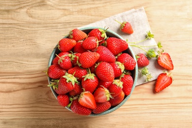 Flat lay composition with fresh strawberries on wooden background